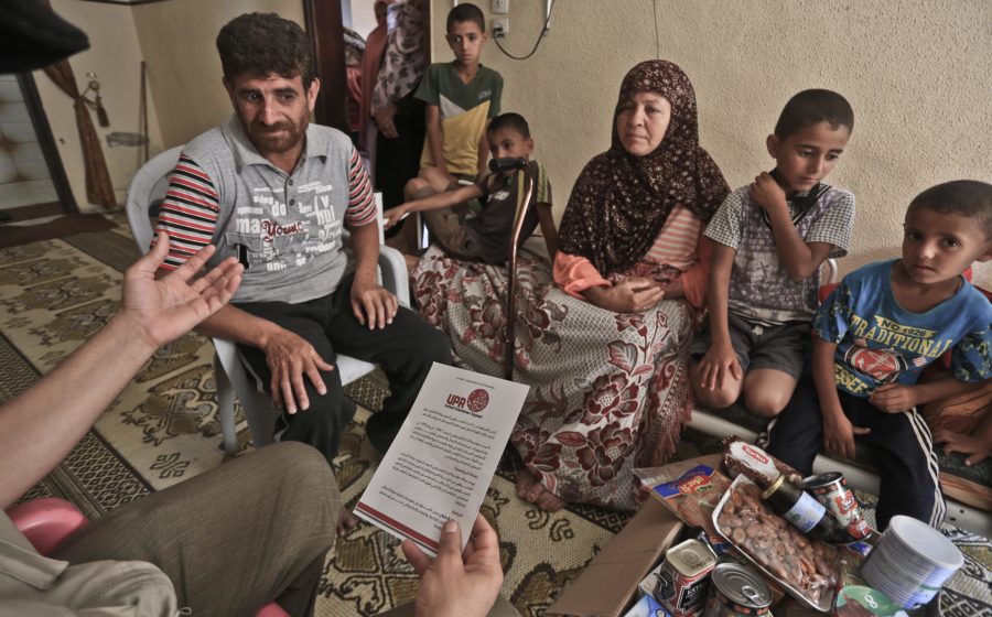 A family in Gaza receives a food parcel during Ramadan.