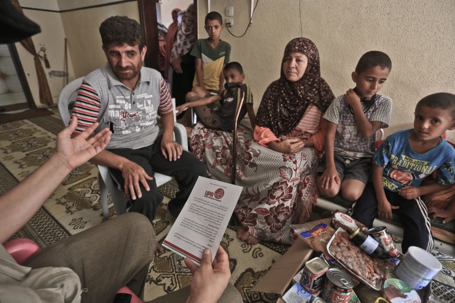 A family in Gaza receives a food parcel during Ramadan.