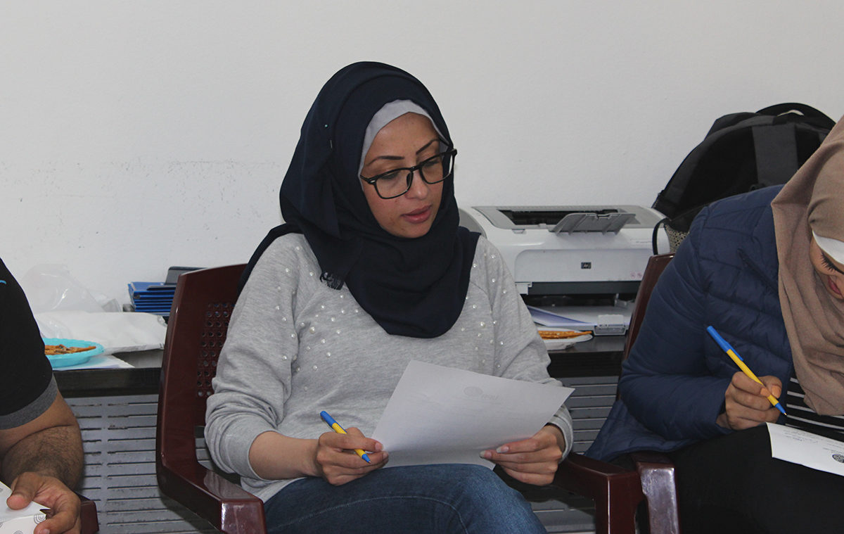 A Gaza teacher reviews notes on trauma.