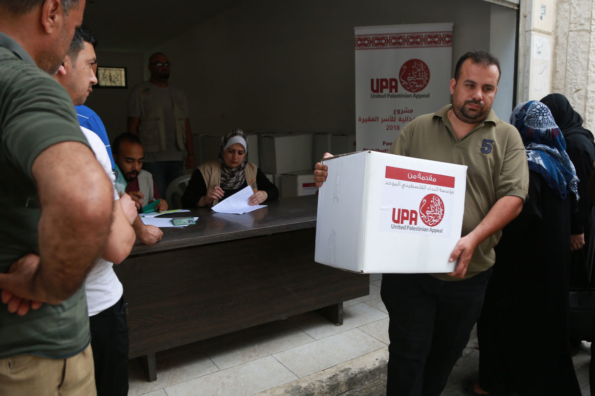 A man picks up his food parcel during Ramadan.