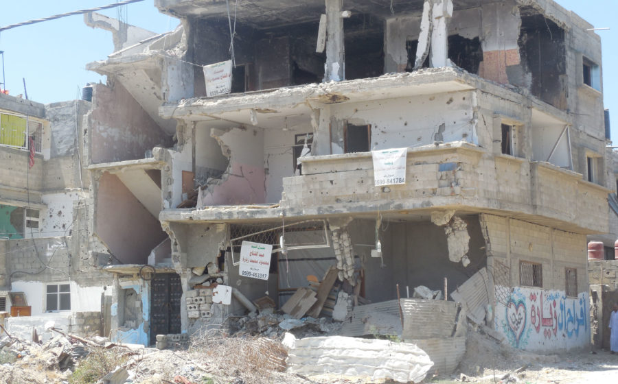 Surveying the damage in Gaza after the 2014 war.