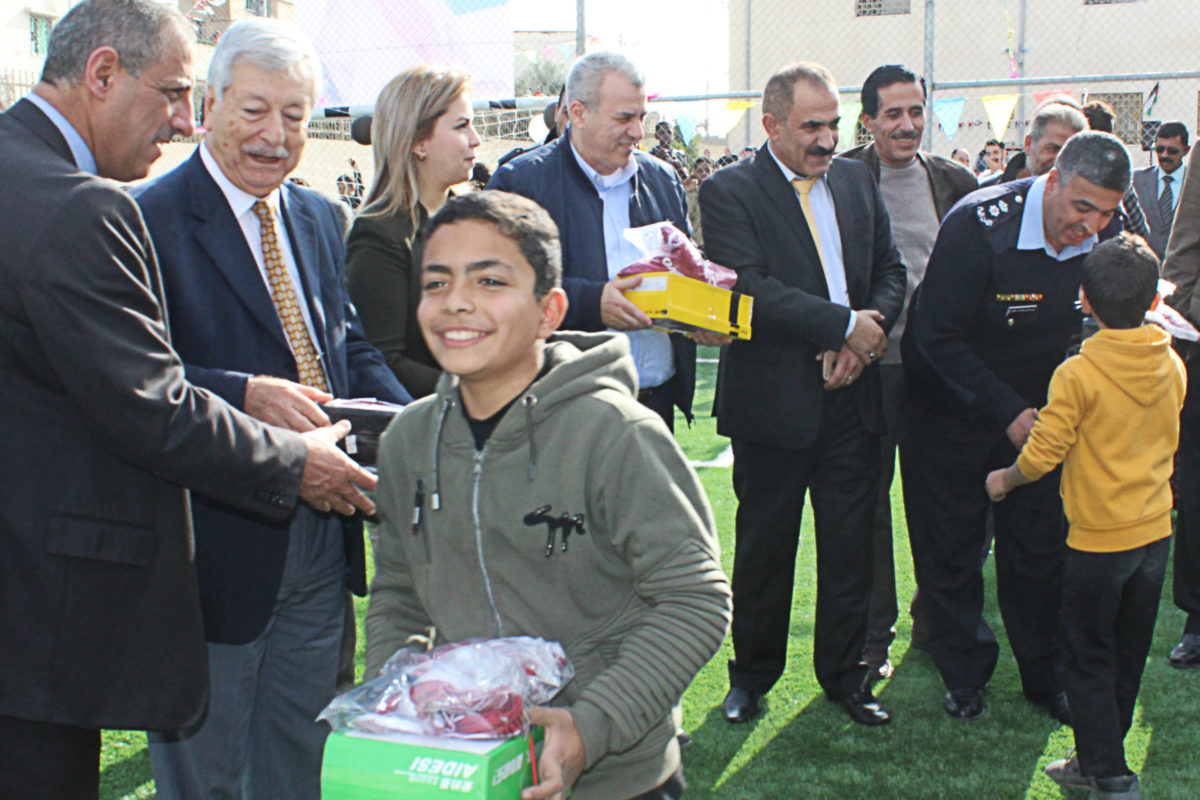 A child receives new shoes and a jersey in Hittin Camp in Jordan.