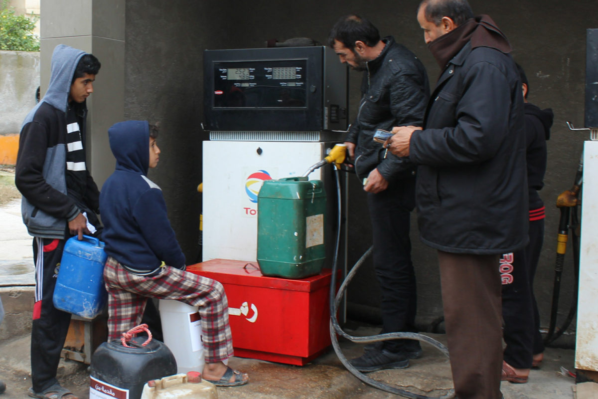 Children wait in line to fill up their container of kerosene in Jordan.