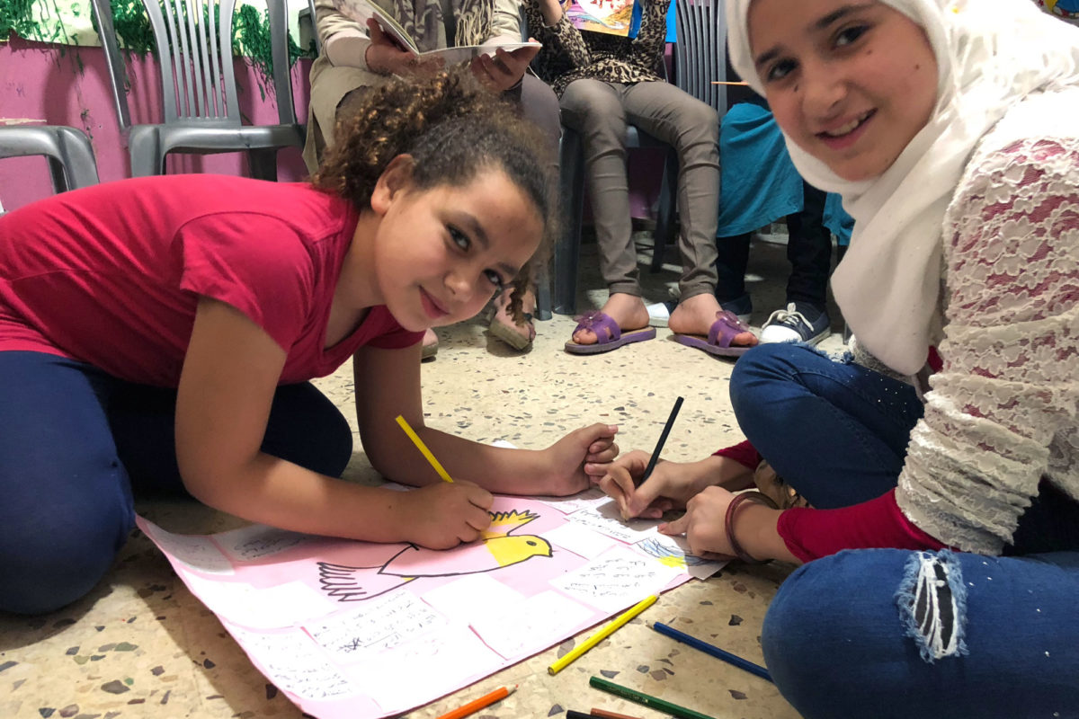 Young girls coloring in Lebanon.