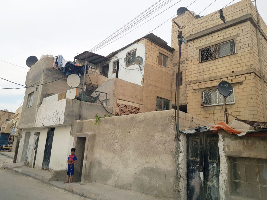 Boy looks out at street in Hittin Camp, Jordan.