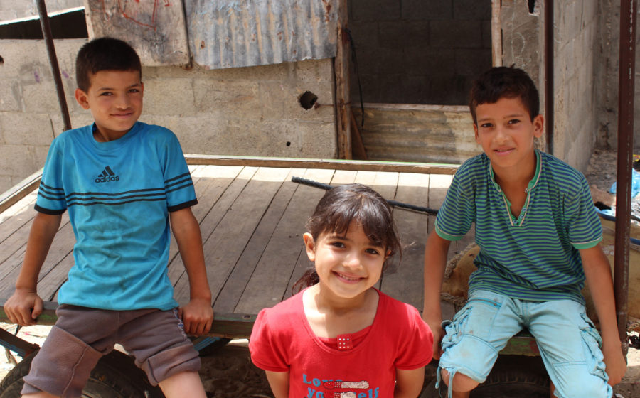 Gaza children sit outside their dwelling in Gaza.