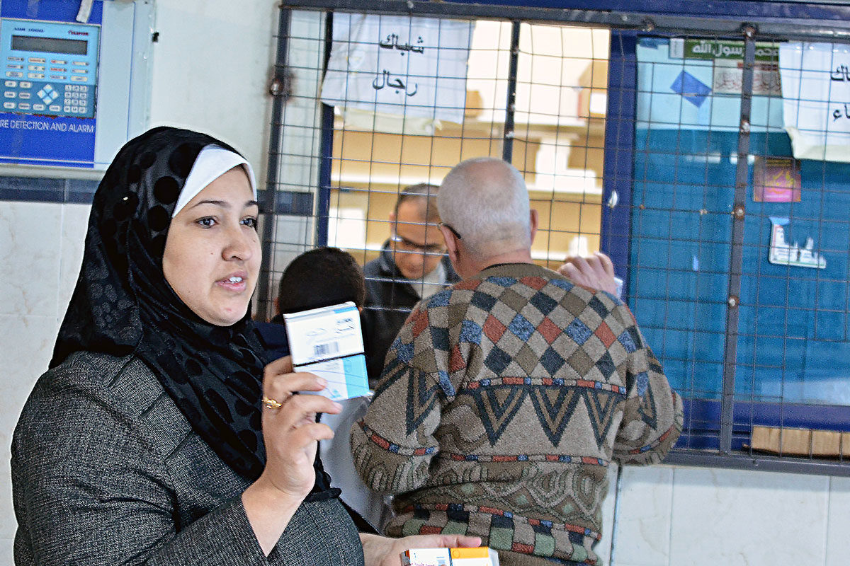 Dalia receives free medicine in Gaza.