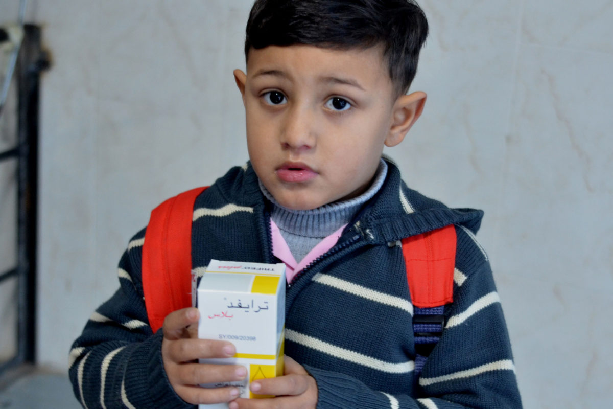 A young boy receives free medicines in Gaza.