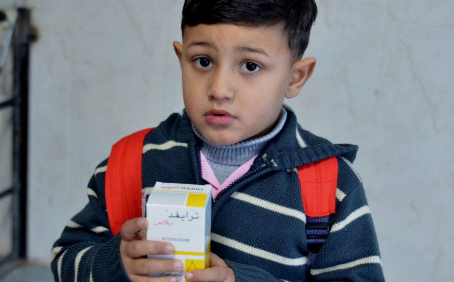 A young boy receives free medicines in Gaza.