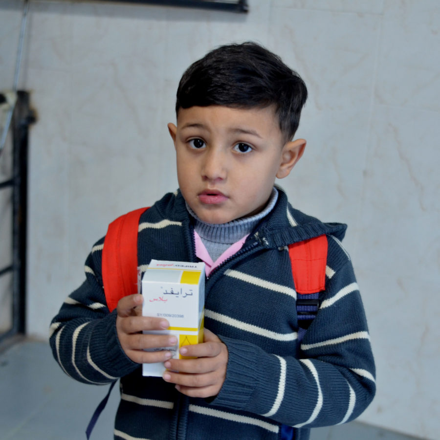 A young boy receives free medicines in Gaza.