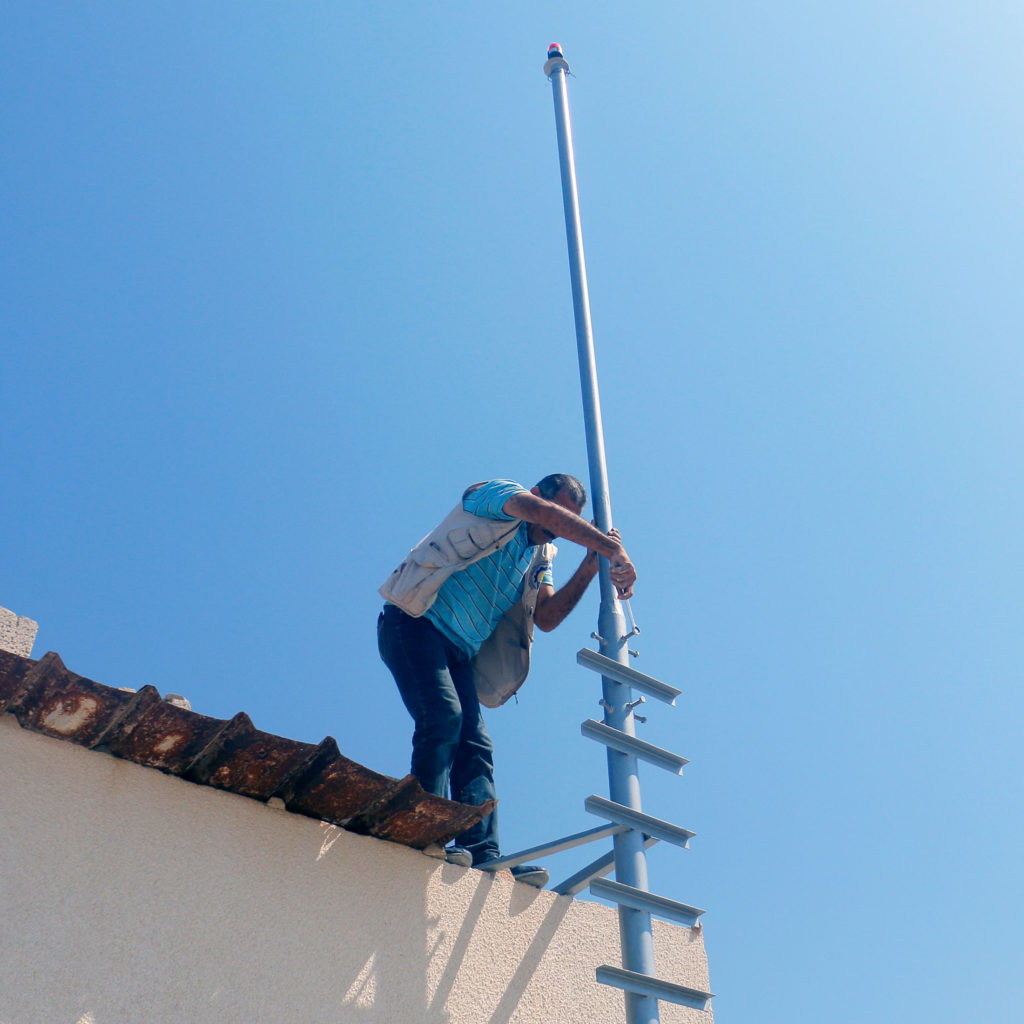 Installing a solar light in Gaza.