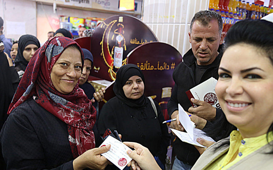 Nisreen handing out food vouchers in Jordan.