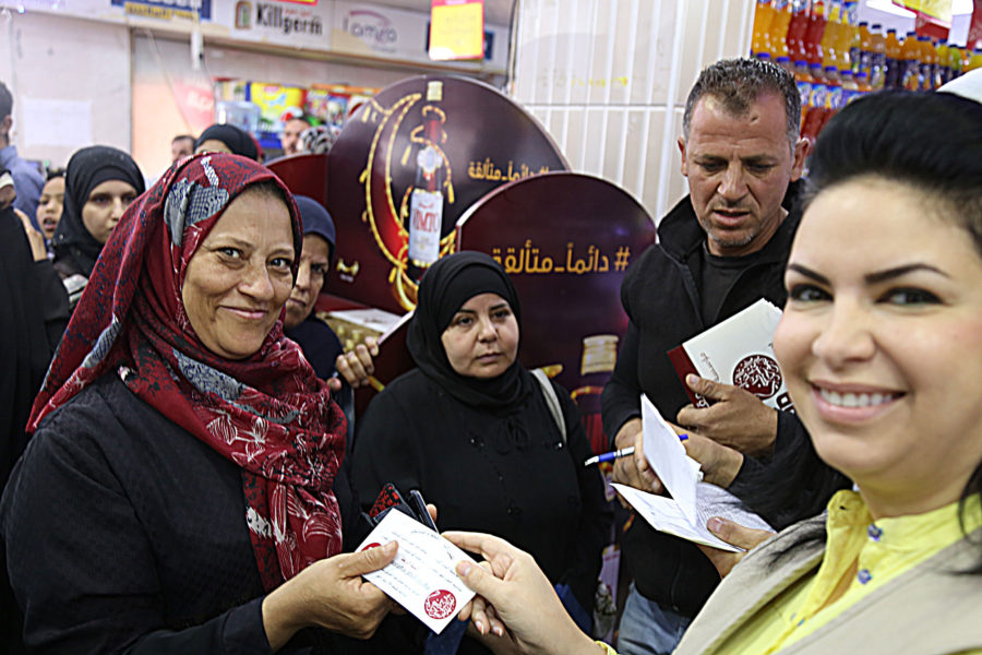 Nisreen handing out food vouchers in Jordan.