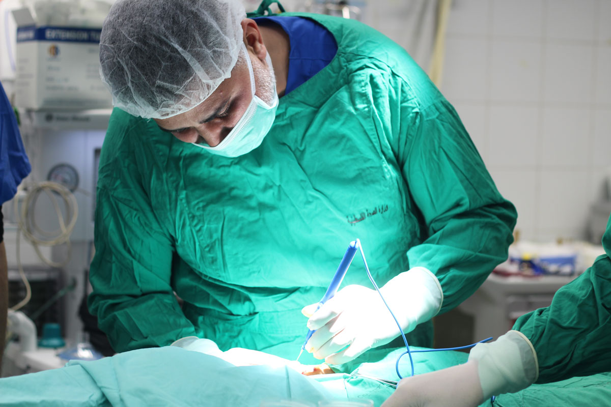 Dr. Abu Hatab performs surgery on a child.