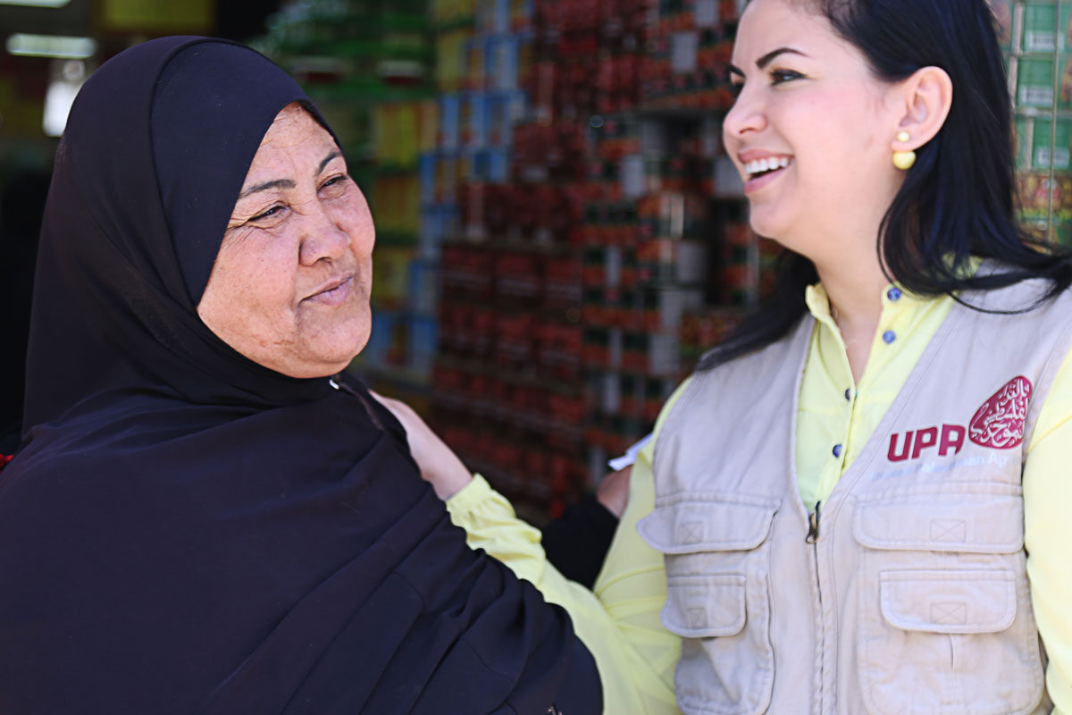 Nisreen comforts a woman in Jordan.
