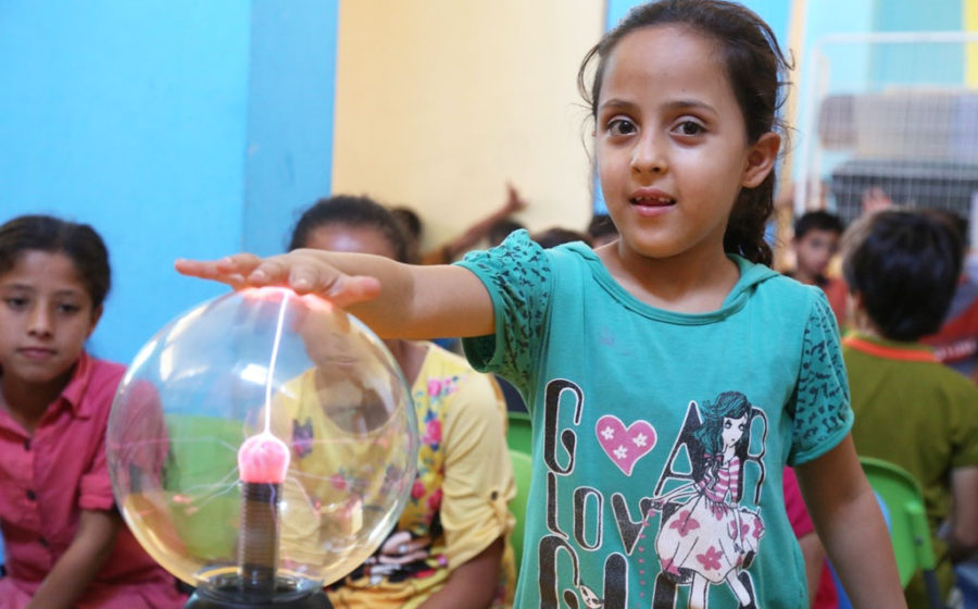 A child plays with science tools in Gaza.