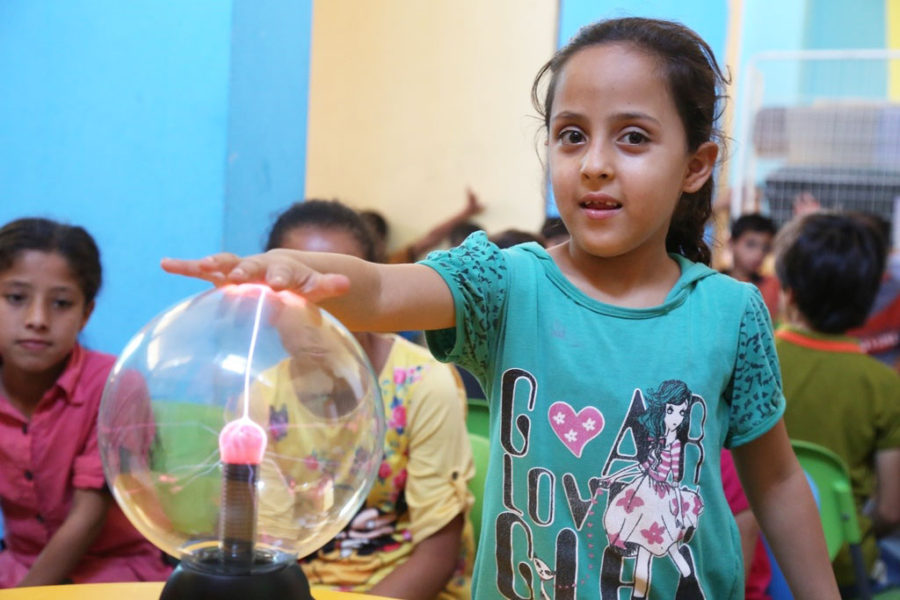 A child plays with science tools in Gaza.