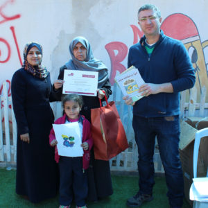 Islam and Khader gift a tool kit to a parent in Gaza.