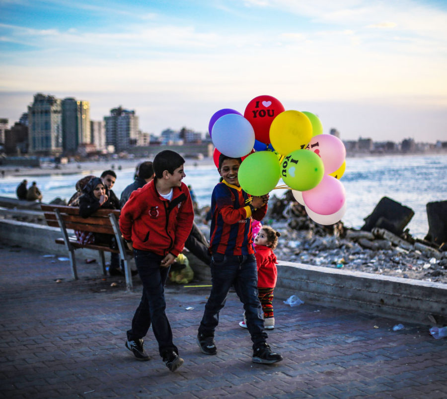 Kids walk with balloons in Gaza.